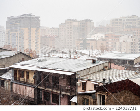 rain and snow over apartment buildings in winter rain and snow over apartment buildings in winter 124018731