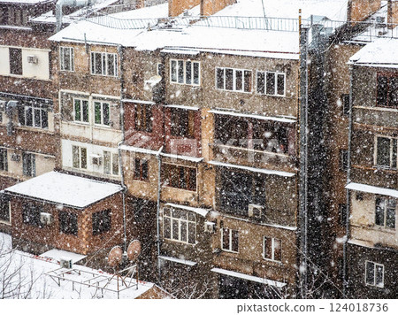 snowfall and facades of urban houses on winter day snowfall and facades of urban houses on winter day 124018736