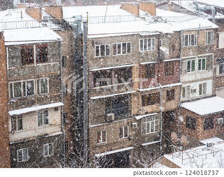 snowfall and facades of buildings in winter snowfall and facades of buildings in winter 124018737