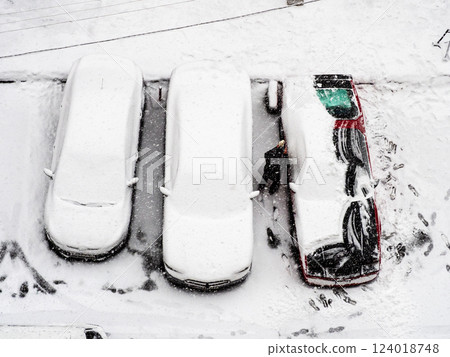 above view of driver removing snow from car above view of driver removing snow from car 124018748