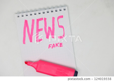 The inscription with a felt tip pen on a piece of paper in a notebook is fake news. The inscription with a felt tip pen on a piece of paper in a notebook is fake news. 124019338