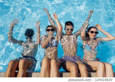 Cute teens in swimsuits and sunglasses in the pool. Cute teens in swimsuits and sunglasses in the pool. 124019820