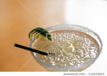 Margarita cocktail in a glass glass on a blurred background Margarita cocktail in a glass glass on a blurred background 124020043