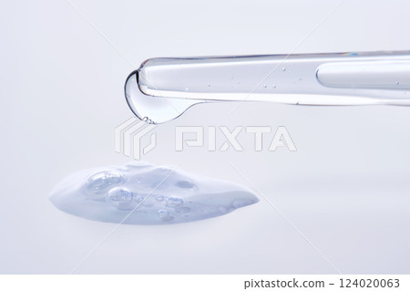 Pipette with delicate blue serum close-up. 124020063