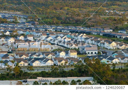 Wooden frames of new cheap American homes under construction. Development of residential housing in the USA Wooden frames of new cheap American homes under construction. Development of residential housing in the USA 124020087