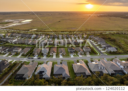 Wealthy residential area in USA suburbs. Rich neighborhood with expensive suburban homes in southwest Florida Wealthy residential area in USA suburbs. Rich neighborhood with expensive suburban homes in southwest Florida 124020112
