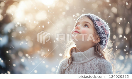 Joyful Child Watching Snowfall on a Winter Day 124020225