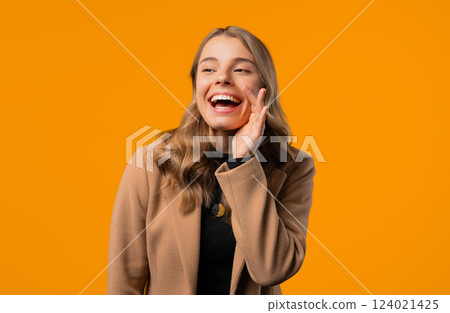 Attention, portrait of businesswoman shouting, holding hand near open mouth Attention, portrait of businesswoman shouting, holding hand near open mouth 124021425