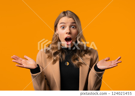 Surprised businesswoman, she expresses WOW, cant believe. Impressed lady trying to get attention. Concept of sales, profitable offer. Excited girl on yellow background 124021455