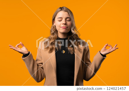 Tranquil businesswoman relaxing, meditating, refuses stress. breathes,calms down 124021457