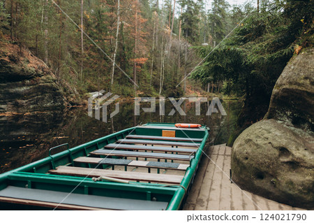 Boat with water reflection at a river pier. Texture of sandstone, The National park Adrspach Teplice rocks. High quality photo. Nature background Boat with water reflection at a river pier. Texture of sandstone, The National park Adrspach Teplice rocks. High quality photo. Nature background 124021790