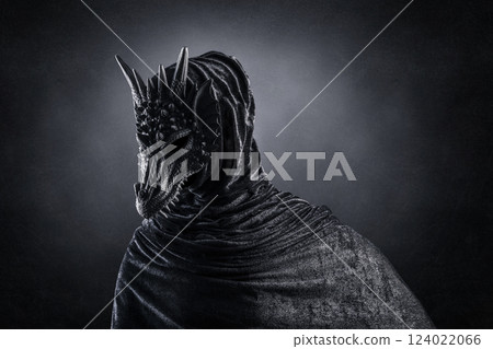 Black dragon with hooded cloak over dark misty background with clipping path 124022066