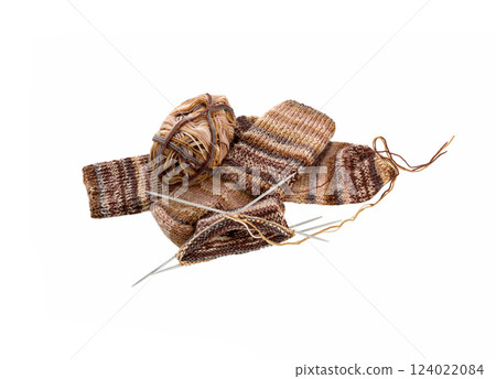 Knitted sock, ball of yarn and knitting needles on a white 124022084