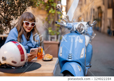 Stylish Italian Woman Enjoying Aperitivo at a Roman Cafe 124022284
