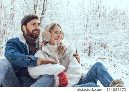 Happy couple enjoying time in a winter forest together Happy couple enjoying time in a winter forest together 124023273