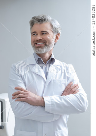 Gray-haired bearded mid aged caucasian doctor looking confident and contented 124023285