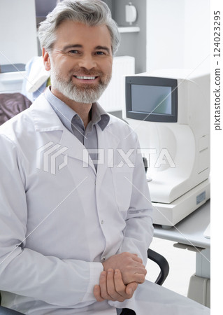 Male specialist at his workplace in hospital near modern optical instruments 124023295