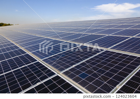 Office building with solar roof. Blue photovoltaic panels for producing clean ecological electric energy. Investing in renewable electricity concept Office building with solar roof. Blue photovoltaic panels for producing clean ecological electric energy. Investing in renewable electricity concept 124023604