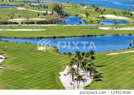 Oceanfront golf course in sunny Florida. Outdoor sport grounds with green grass lawns in Boca Grande, small town on Gasparilla Island Oceanfront golf course in sunny Florida. Outdoor sport grounds with green grass lawns in Boca Grande, small town on Gasparilla Island 124023606