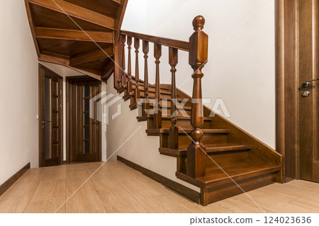 Modern brown oak wooden stairs and doors in new renovated house interior Modern brown oak wooden stairs and doors in new renovated house interior 124023636