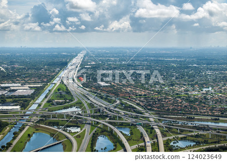 Massive highway intersection in American city area. Stacked elevated interchange lanes for express passing of car traffic. Miami, Florida Massive highway intersection in American city area. Stacked elevated interchange lanes for express passing of car traffic. Miami, Florida 124023649