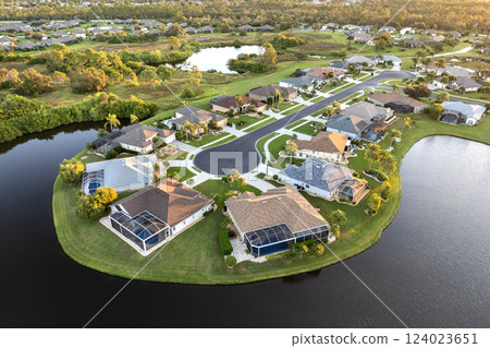 Low-density private homes at sunset. Rural street cul-de-sac dead end in residential suburbs with upscale suburban houses outside of Sarasota, Florida 124023651