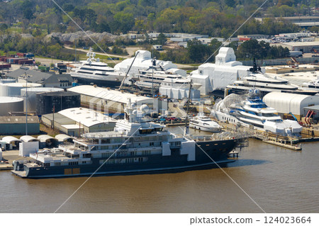 Large luxury yacht under construction in shipyard with cranes. Assembly of sea vessel 124023664
