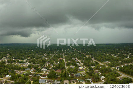 Landscape of dark ominous clouds forming on stormy sky before heavy thunderstorm over rural town area 124023668