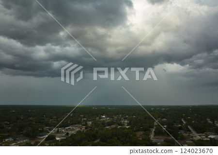Landscape of dark ominous clouds forming on stormy sky before heavy thunderstorm over rural town area Landscape of dark ominous clouds forming on stormy sky before heavy thunderstorm over rural town area 124023670
