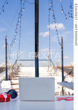 A productive workspace with modern tech outdoor rooftop bright daylight elevated perspective work life balance 124024418