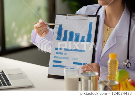 Nutrition report presentation. Nutritionist presenting health data on charts and graphs. 124024483