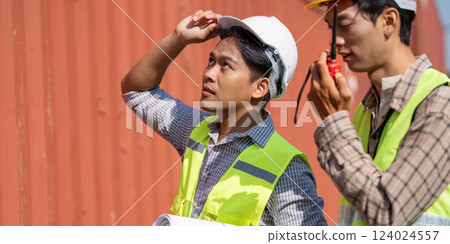 Logistics Planning. Young engineers assessing project details in a work environment. 124024557