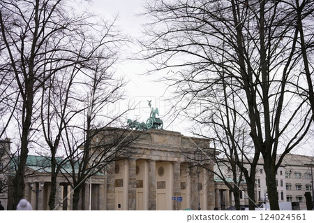 Brandenburg Gate framed by bare winter trees  124024561