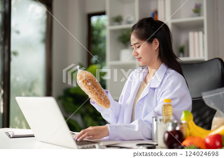 Healthy food options displayed on a table during a nutritionist's consultation with a client. 124024698