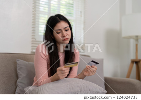 Budgeting and Financial Strain. A woman appears concerned while reviewing her finances, highlighting challenges in managing spending. Budgeting and Financial Strain. A woman appears concerned while reviewing her finances, highlighting challenges in managing spending. 124024735