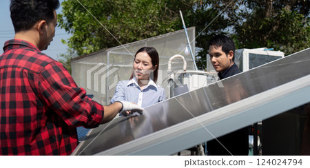 Sustainable Solutions and Team Dynamics. A contractor discusses solar panel technology with partners, emphasizing learning and collaboration in renewable energy. 124024794