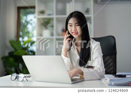 Young professional analyzing financial documents and preparing tax filings in a modern office. Young professional analyzing financial documents and preparing tax filings in a modern office. 124024809