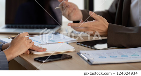 Hands in discussion. Two colleagues engaged in a collaborative planning session. Hands in discussion. Two colleagues engaged in a collaborative planning session. 124024934