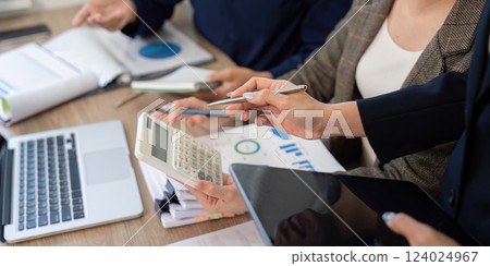 Data Analysis and Financial Reports. Team reviewing documents to strategize tax solutions and business growth. 124024967