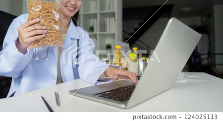 Nutritional assessment. A dietitian showcasing healthy food choices in a consultation. Nutritional assessment. A dietitian showcasing healthy food choices in a consultation. 124025113