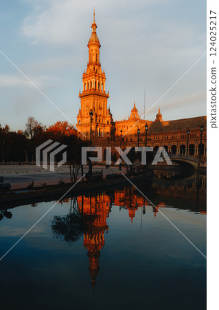 Sunset reflection on plaza de Espana tower in seville's historic architecture. Spain Square, Plaza 124025217