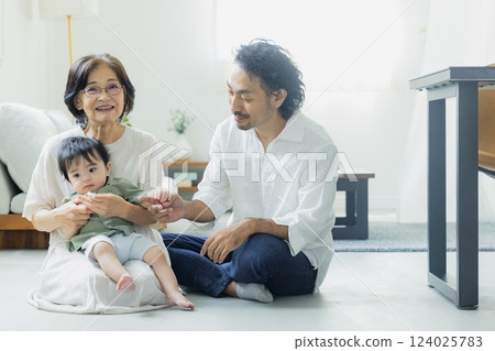 Three generations of family in the living room 124025783