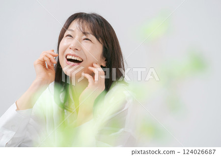 Portrait of a smiling woman in her 50s doing skin care Portrait of a smiling woman in her 50s doing skin care 124026687