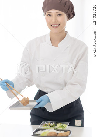 Young woman working at a food factory 124026726
