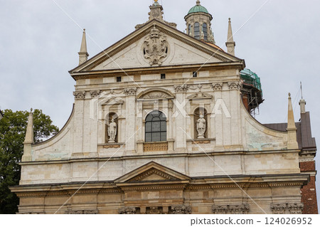 Baroque Church Facade with Sculptures, Ornate Decorations, and a Historic Dome in a European City 124026952