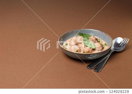 Meatballs in a bowl on a brown background 124028229
