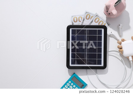 Portable solar panel with calculator and money 124028246
