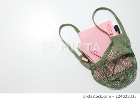 Pink notebook with stationery in a bag 124028333