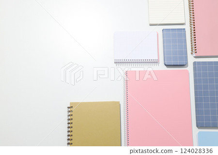 Different notebooks lie on a white background 124028336