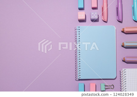 Two notebooks with stationery on a violet background Two notebooks with stationery on a violet background 124028349